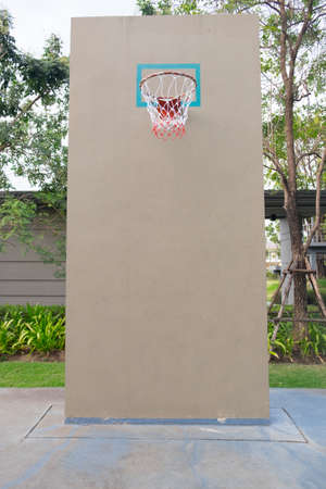 Basketball hoop on empty outdoor court at club houseの写真素材