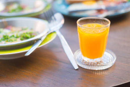 Natural orange juice on wood table, breakfastの写真素材