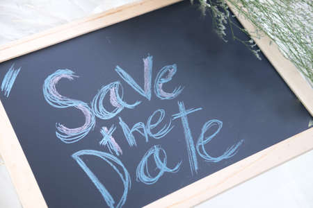 Chalkboard with English text save the date. Wedding concept