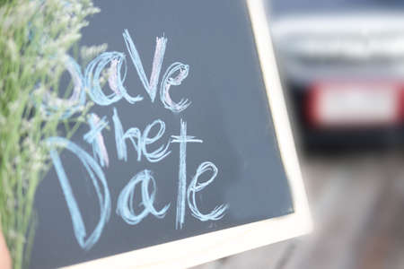 save the date, text message on wood chalkboardの写真素材