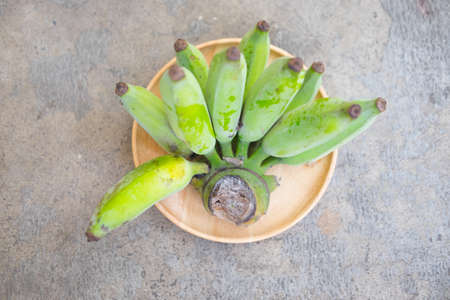 Close up a bunch of young green bananasの写真素材