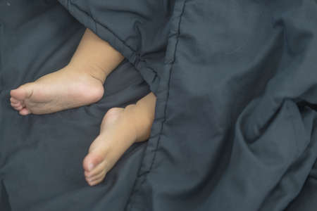 baby's feet wrapped in a blue blanket