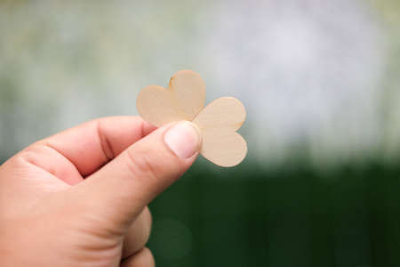 Wood hearts in hand, Valentine's day. Love wedding concepts.の写真素材