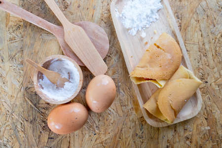 Homemade Thai rolled crepe and ingredients on table