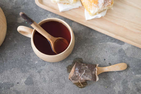 Hot tea in wood cup with bagtea, top viewの写真素材