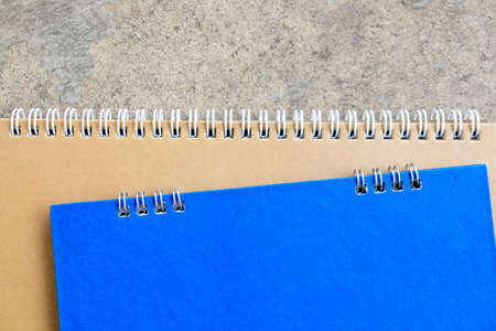 Close up of brown and blue blank notebook with spiral