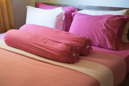 Pink king size bed in apartmentの写真素材