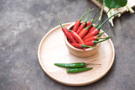 chili peppers in wooden bowlの写真素材