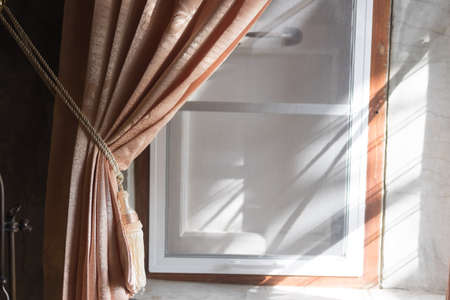 Beautiful curtain tie by curtain strap with sunlightの写真素材