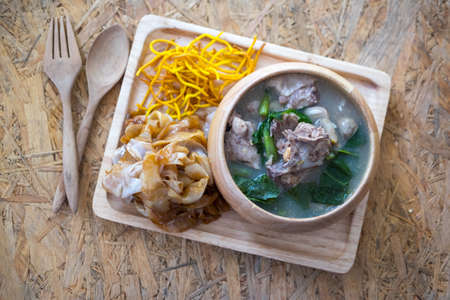 Wide noodles and crispy yellow noodle with in a creamy gravy sauce, in Thai language call is "Rad Na"の写真素材