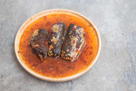 Fried mackerel in chilli sauce is made of sweet and spicy chili sauce poured into fried mackerels on wooden dishの写真素材