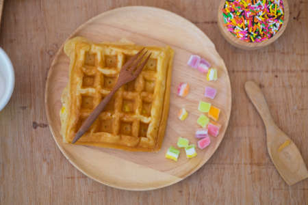 Homemade waffles for breakfast time on wood trayの写真素材