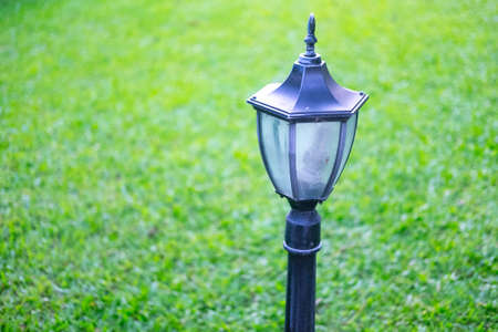 Pole metal black vintage lamp on green grassの写真素材