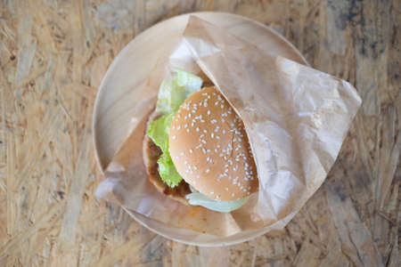 Hamburgers with fresh vegetables on craft wrapping paperの写真素材