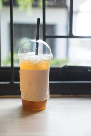 cup of ice lemon tea on wooden table in coffee shopの写真素材