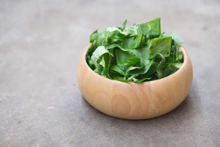 Slice of kale in wood bowl ready to cook Thai style food