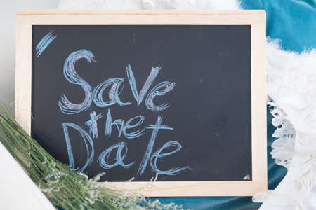 Business message SAVE THE DATE written with chalk on wooden mini blackboard labelsの写真素材