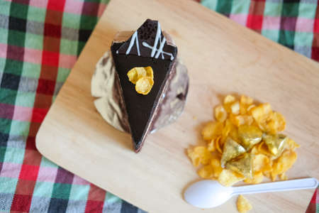 Sweet brownie chocolate cream cake topped with corn flakesの写真素材