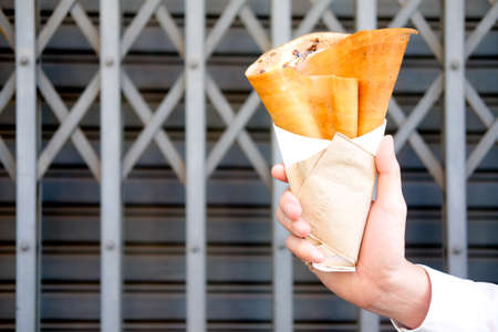 Sweet dessert crispy pancake in handの写真素材