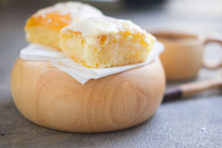 Toast with butter and sprinkling with sugar on wood bowlの写真素材