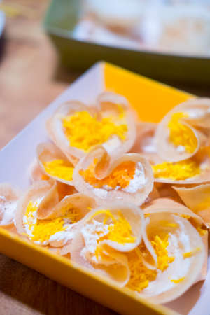 Thai crepes filled with sweet coconut cream and salted shredded coconutの写真素材