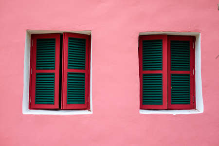 Two windows on pink wall, lively style of architecture buildingの写真素材