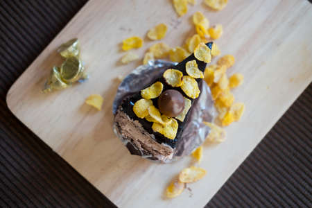 Sweet brownie chocolate cream cake topped with corn flakeの写真素材