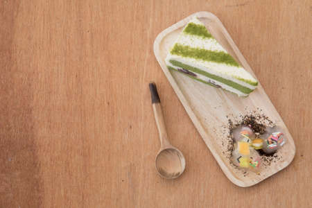 Green tea cake in wood tray on wood backgroundの写真素材