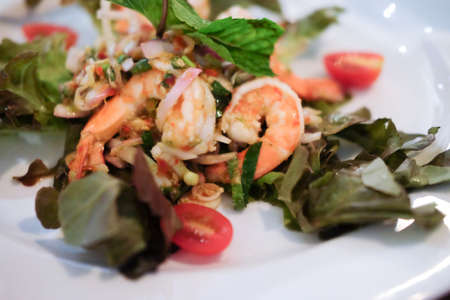 Thai style spicy seafood salad with mixed vegetable and herbの写真素材