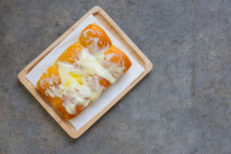 Butter bread sprinkled with sugar on wood tray