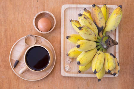 Healthy food set or healthy breakfast  - black coffee, boiled egg and fresh bananaの写真素材