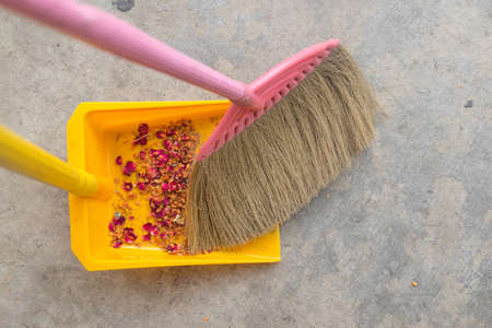 broom sweeping floor into dustpan. top viewの写真素材