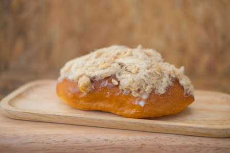 Homemade bun of bread with mayonnaise and pork floss on wood trayの写真素材