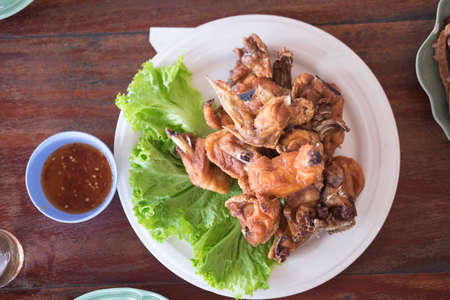 Fried chicken wings and crispy garlic with sweet sauceの写真素材