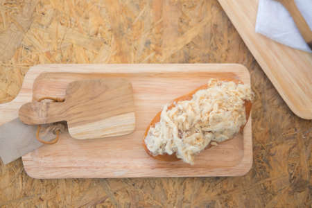 Bread with dried shredded pork on wood tray