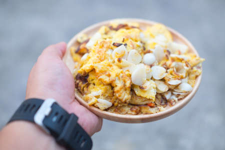 omelette mix pickled garlic in wood dish, Thai homemade style foodの写真素材