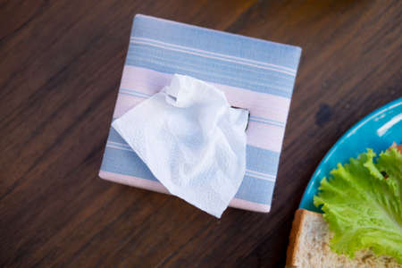 Tissue box made from silk on wood tableの写真素材