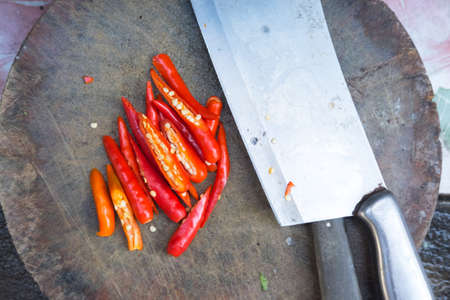 red chilli on wood chopping block with knife, ingredient food Thailand ancient styleの写真素材