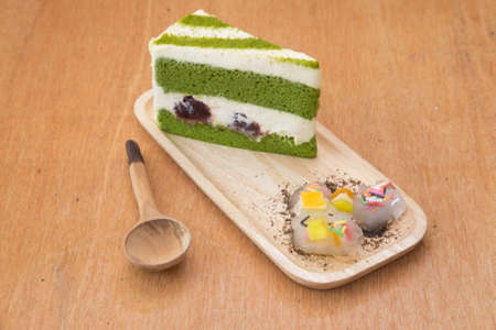 Japanese matcha green tea cake and cream on wood trayの写真素材