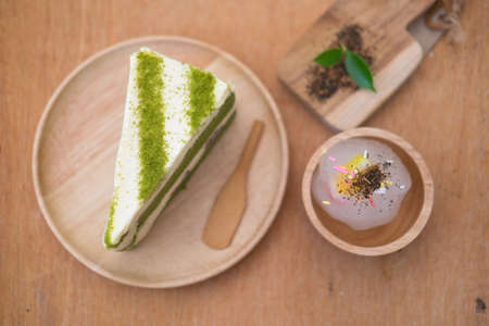 Matcha green tea cake in wood plate (select focus)の写真素材