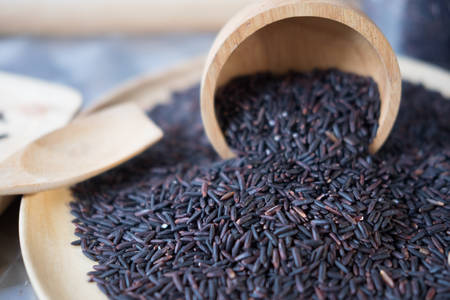 Closeup details of Thai rice berry, rice berry is a cross-bred unmilled rice possessing dark violet grain and Thai Hom Mali Rice.の写真素材