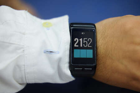 Young man making gestures on a wearable smart watch computer device