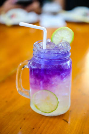 Butterfly pea juice on wood tableの写真素材