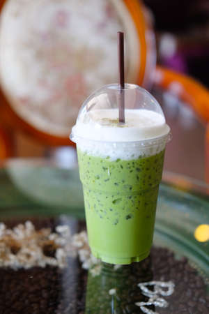 Iced green tea in takeaway cup in coffee shopの写真素材