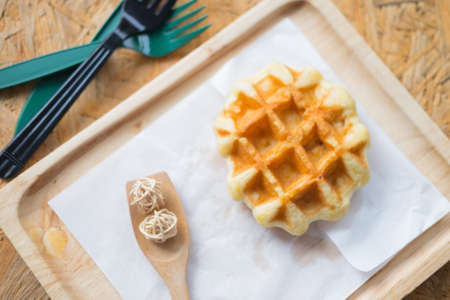 Waffle on wood dish for gourmet breakfastの写真素材