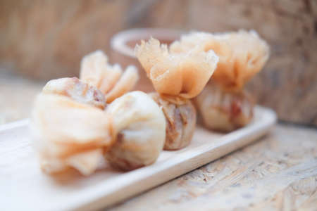 Asian appetizers with sweet chili sauce. Thai called "Toong Tong"の写真素材