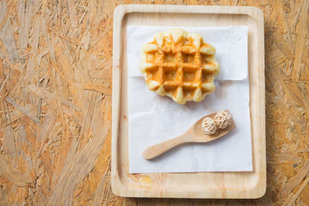 Homemade round Belgian waffles served on wood platesの写真素材