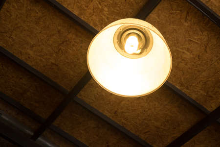 Ceiling lamp on wall in home at night