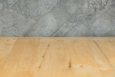 Wood table and cement wall texture background with spaceの写真素材