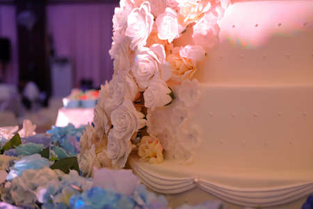 Close up beautiful white wedding cake at wedding receptionの写真素材